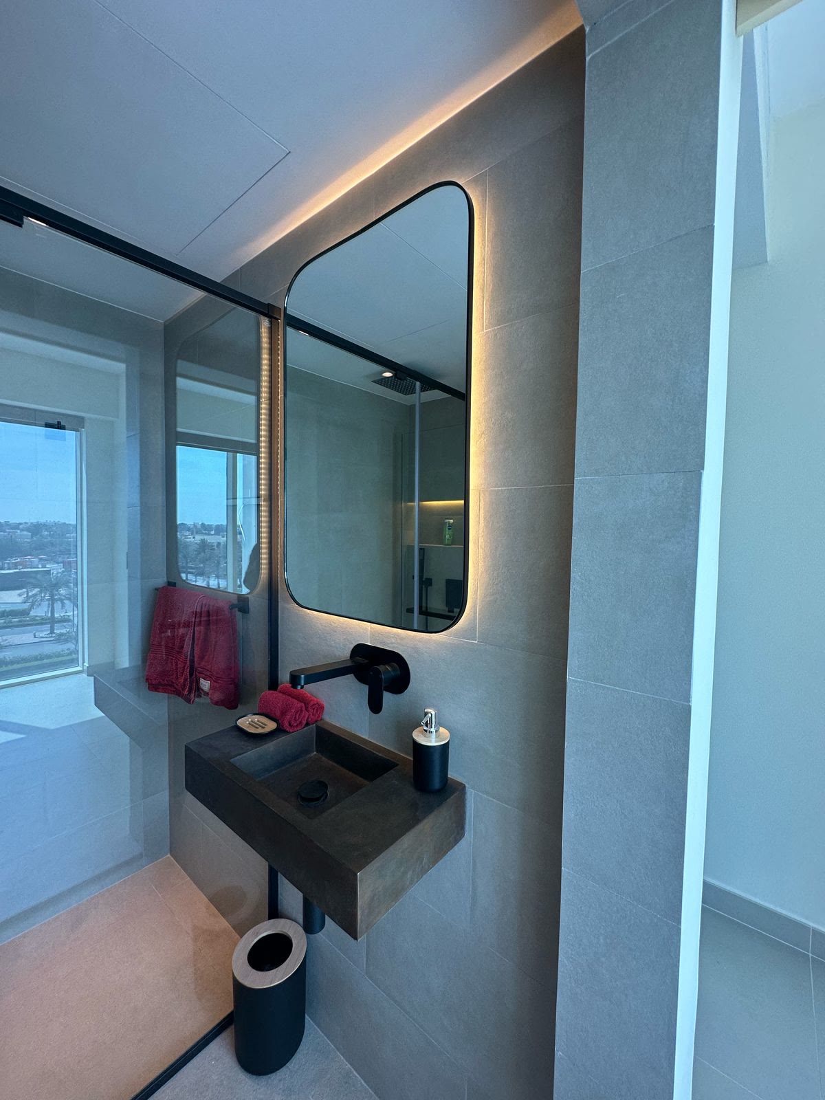Completed shower room vanity and illuminated mirror