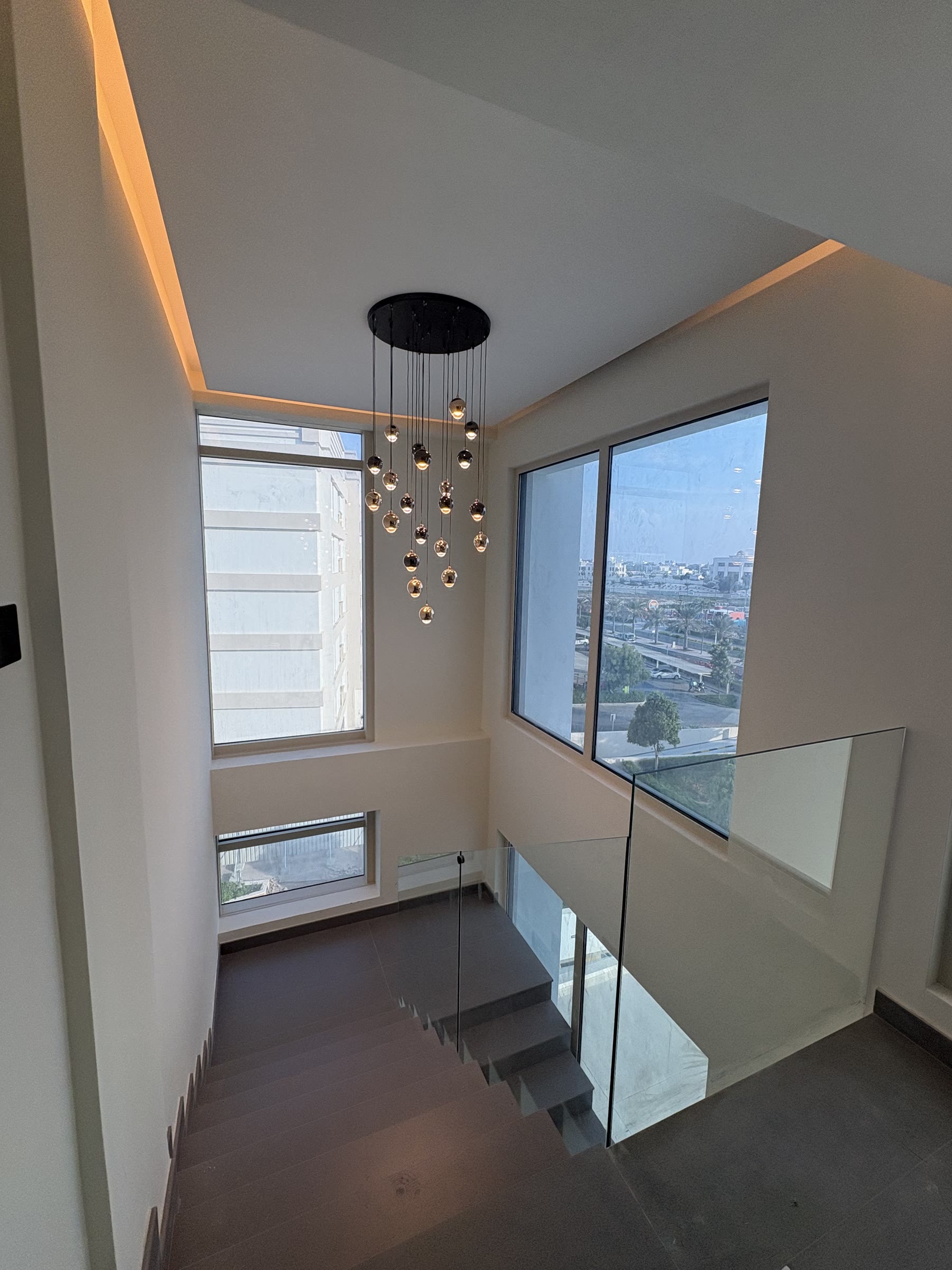 Completed staircase with glass balustrade and feature lighting