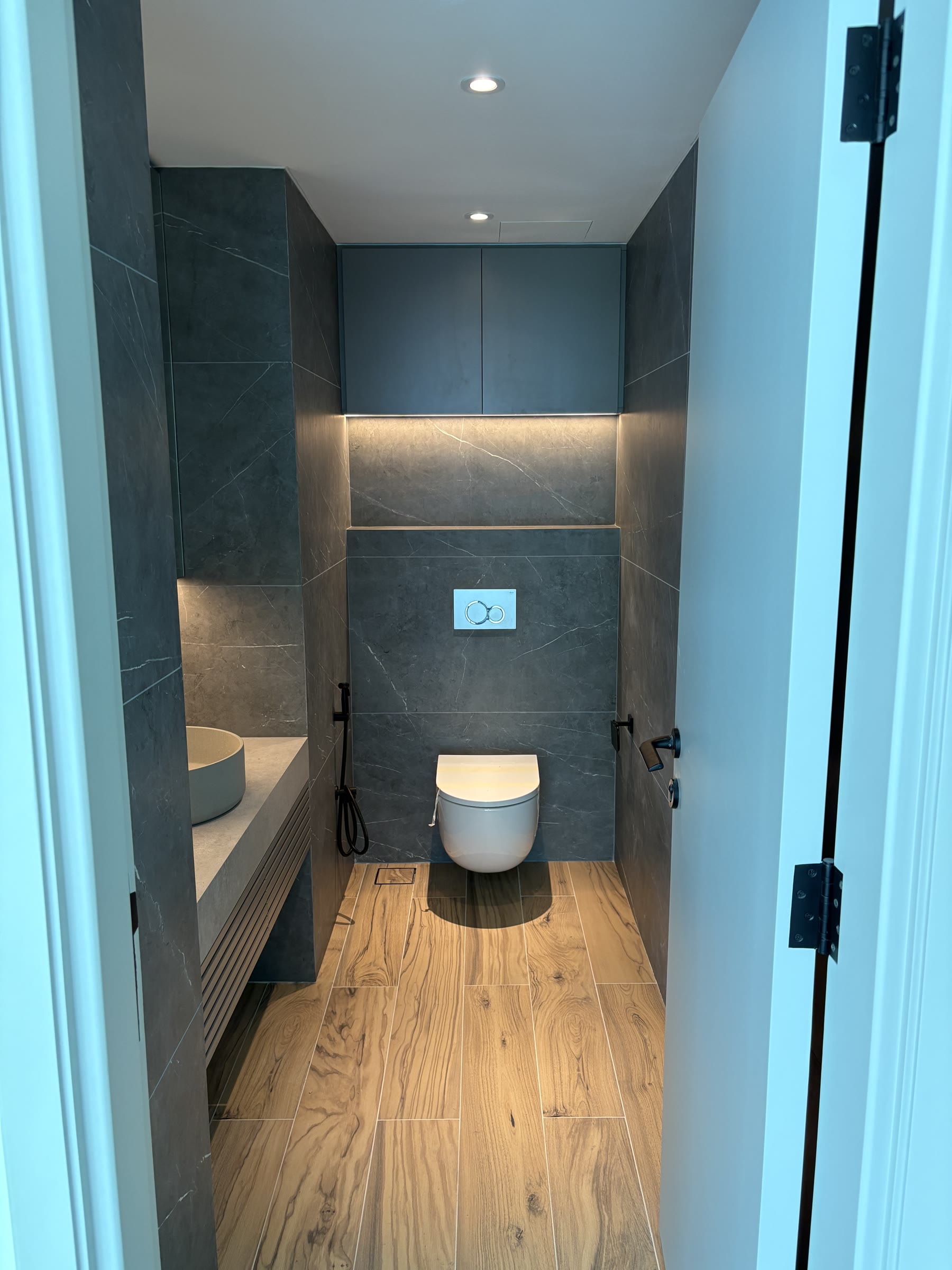 Completed guest toilet with bespoke vanity and timber floor