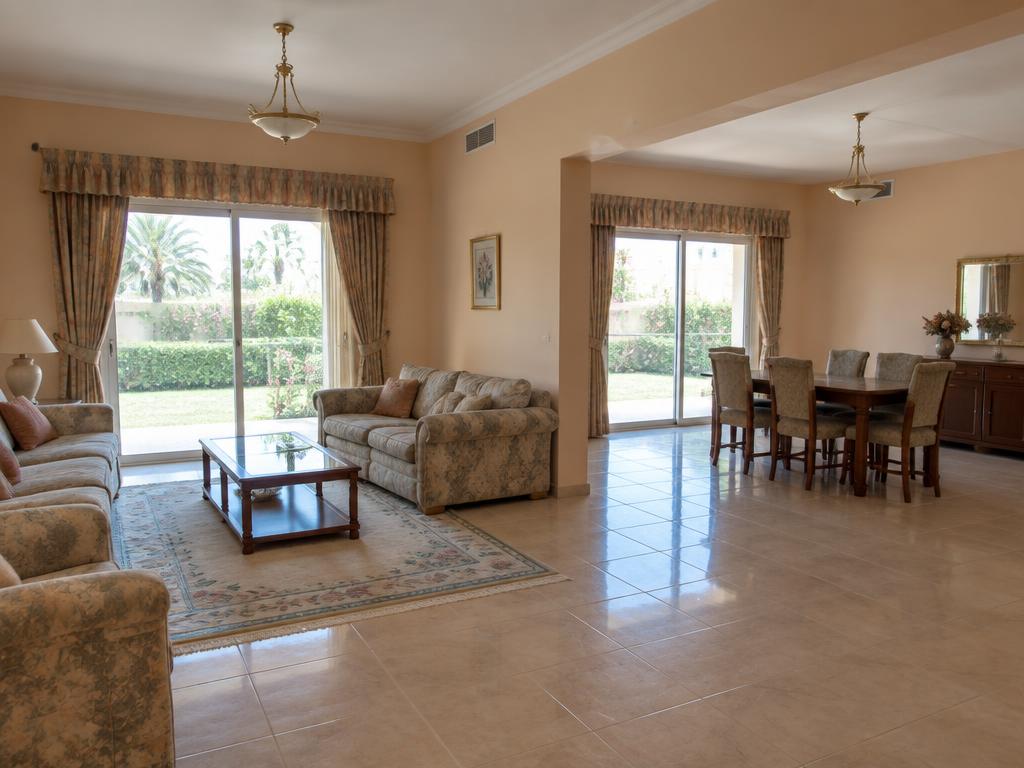 Dated divided living and dining rooms before renovation in Al Hamra Village