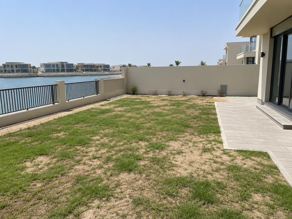 Patchy waterfront villa garden before landscaping in Mina Al Arab, Ras Al Khaimah